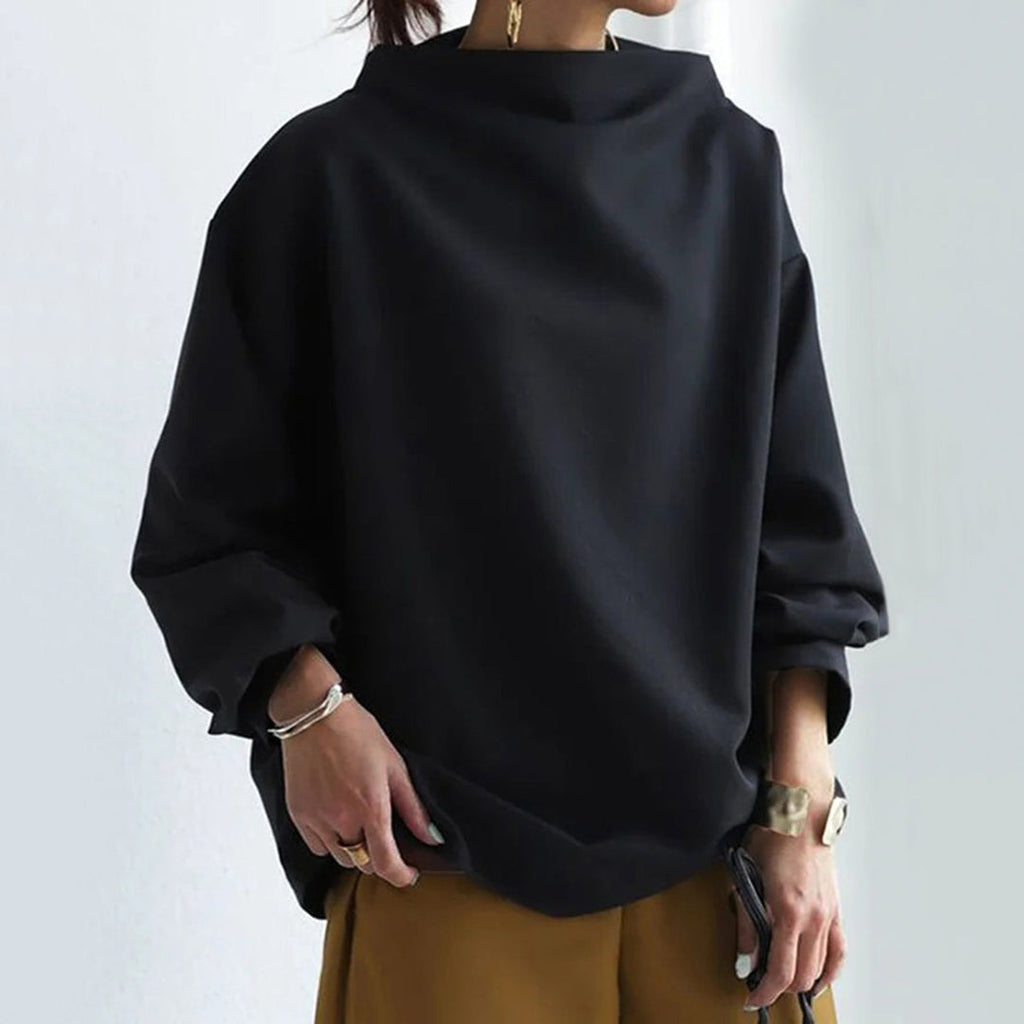 Woman wearing a black oversized funnel neck sweater