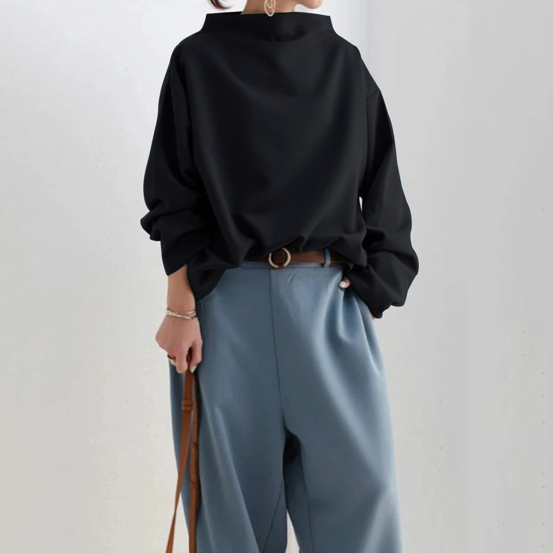 Woman wearing a black oversized sweater with jeans