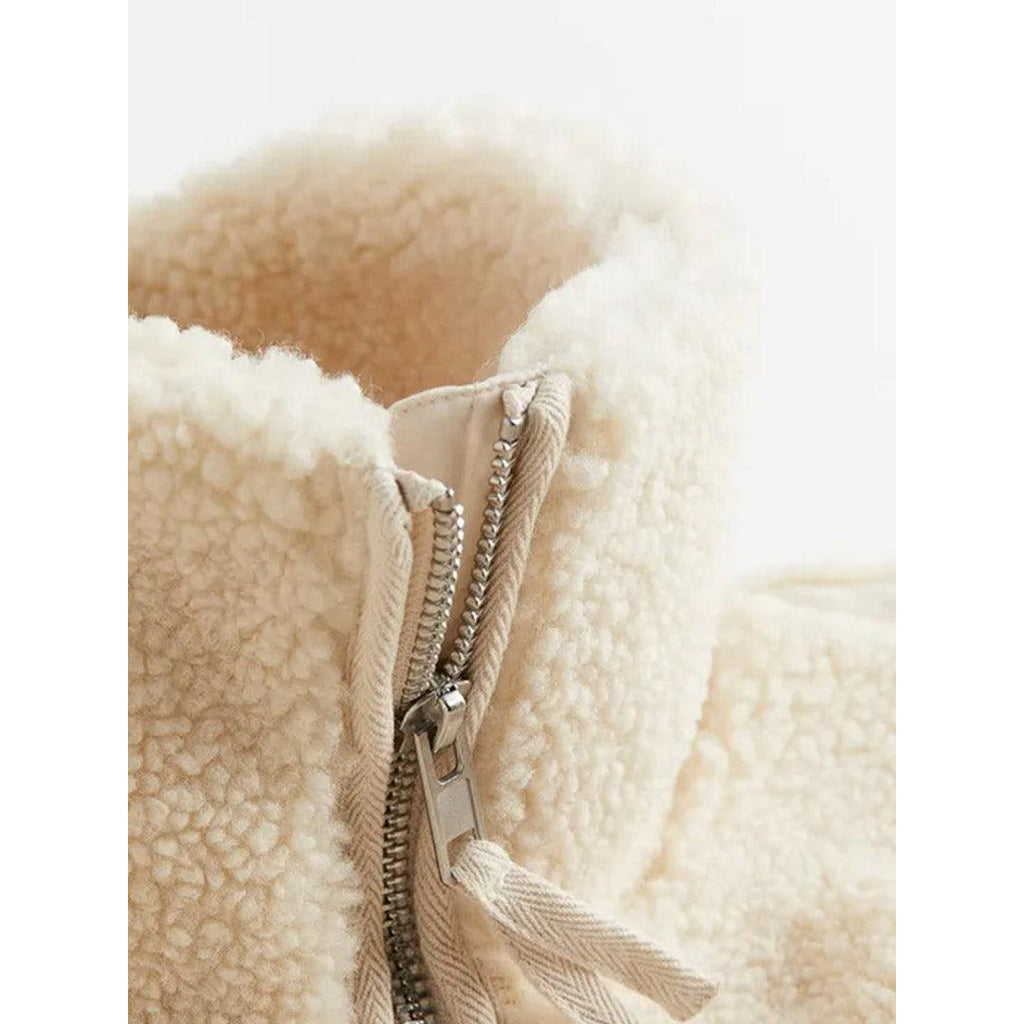 Close-up of the zip and collar on the cream teddy jacket
