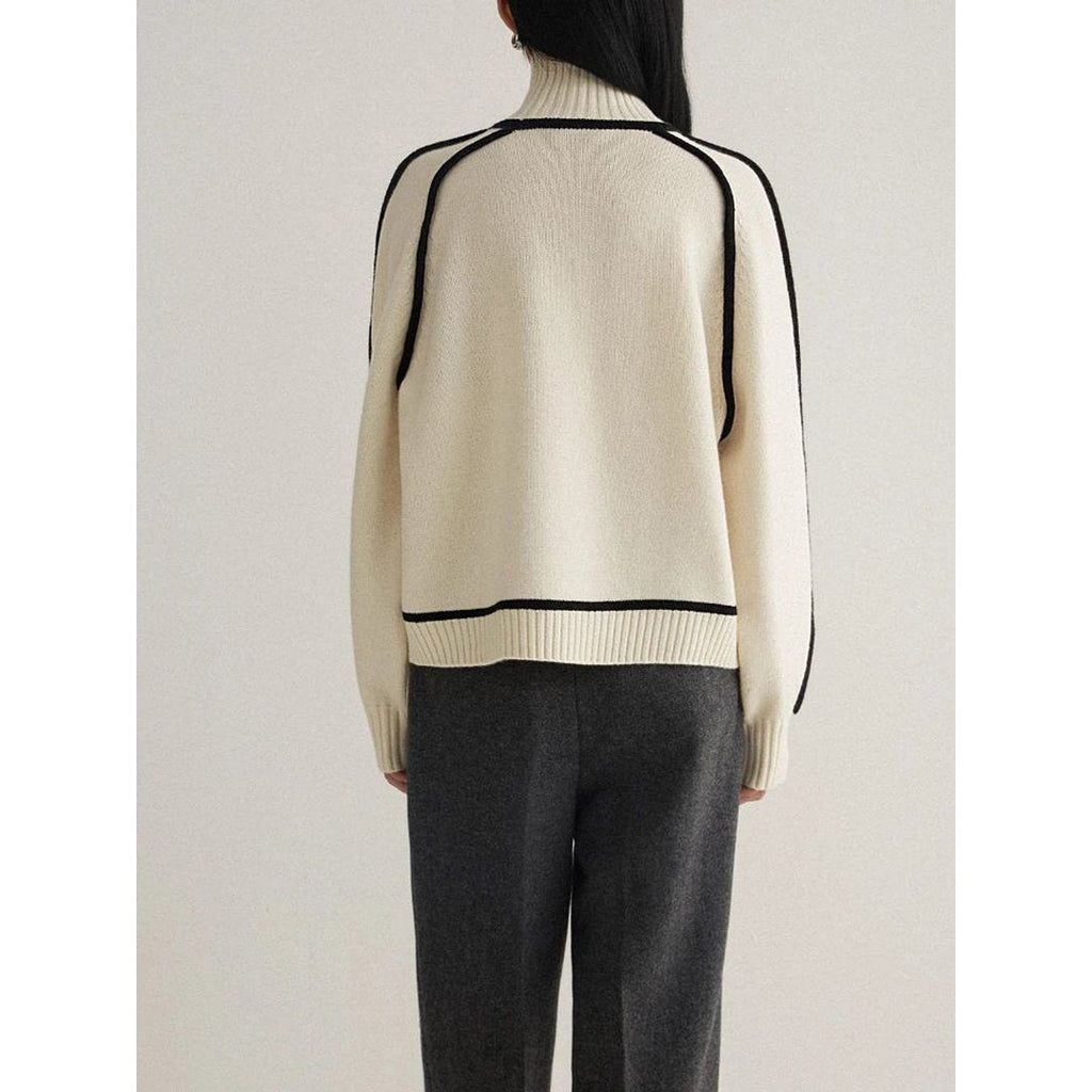 Women's oversized turtleneck sweater with contrast piping in cream, back view