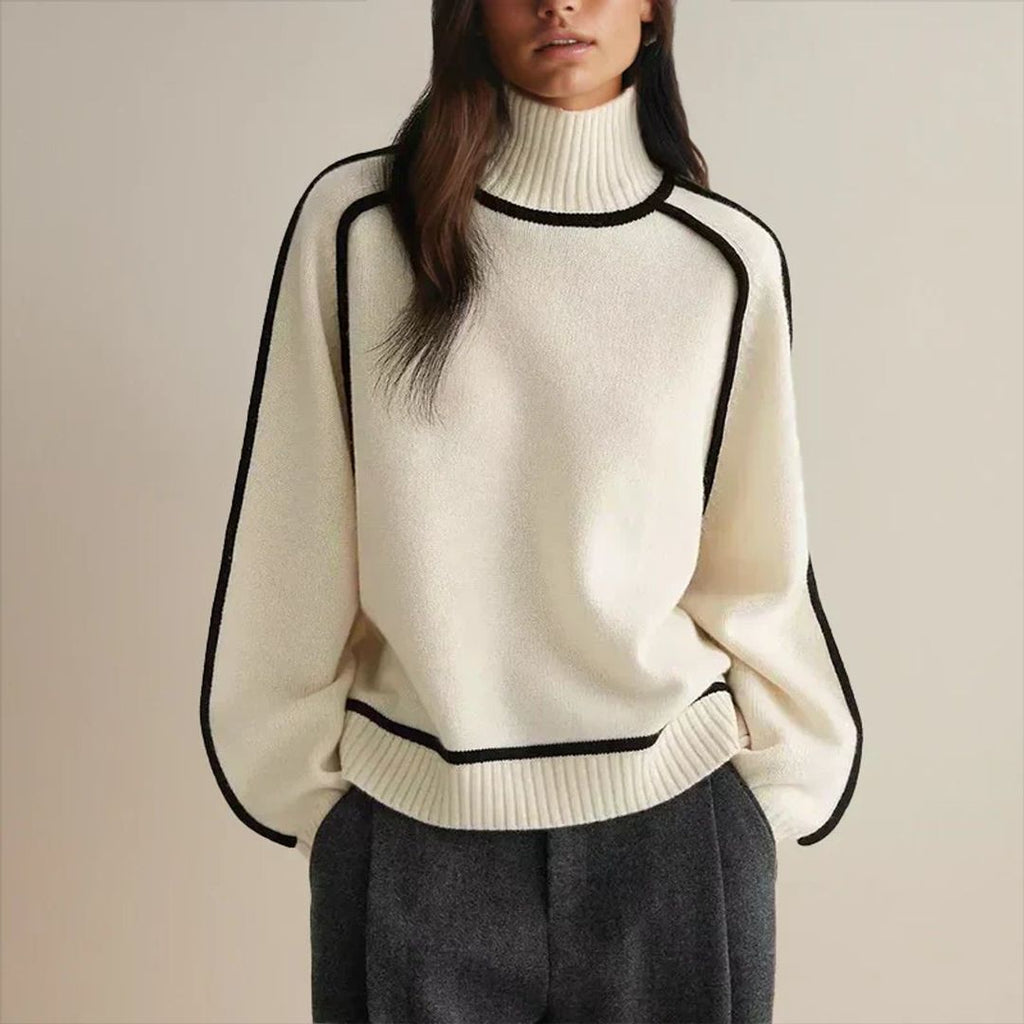 Women's oversized turtleneck sweater with contrast piping in cream, styled with jeans