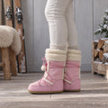 Woman wearing pink snow boots with pom-pom laces