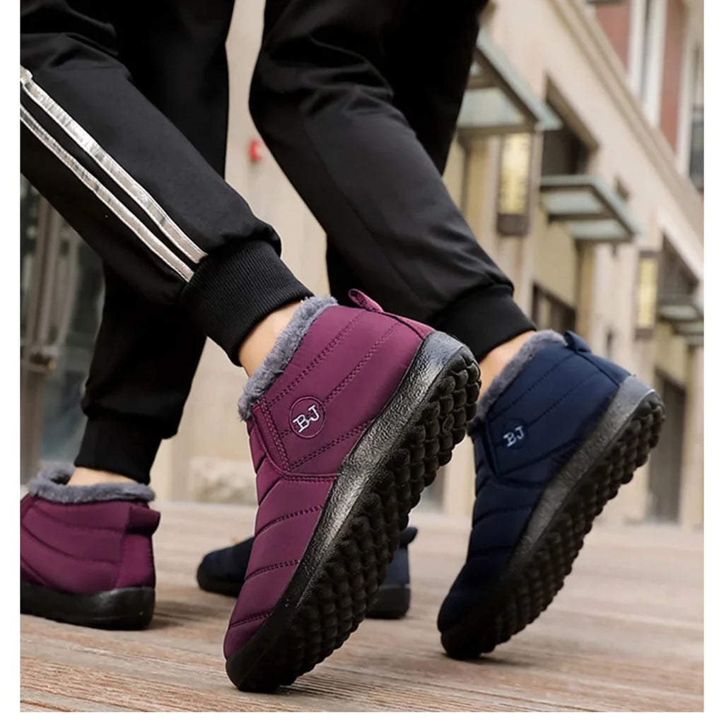 Women's burgundy and navy quilted boots worn outdoors