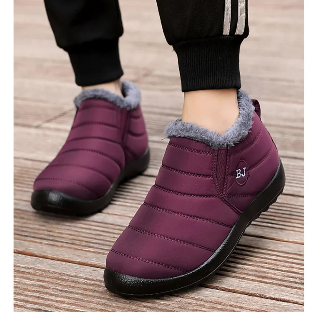 Woman wearing burgundy quilted ankle boots