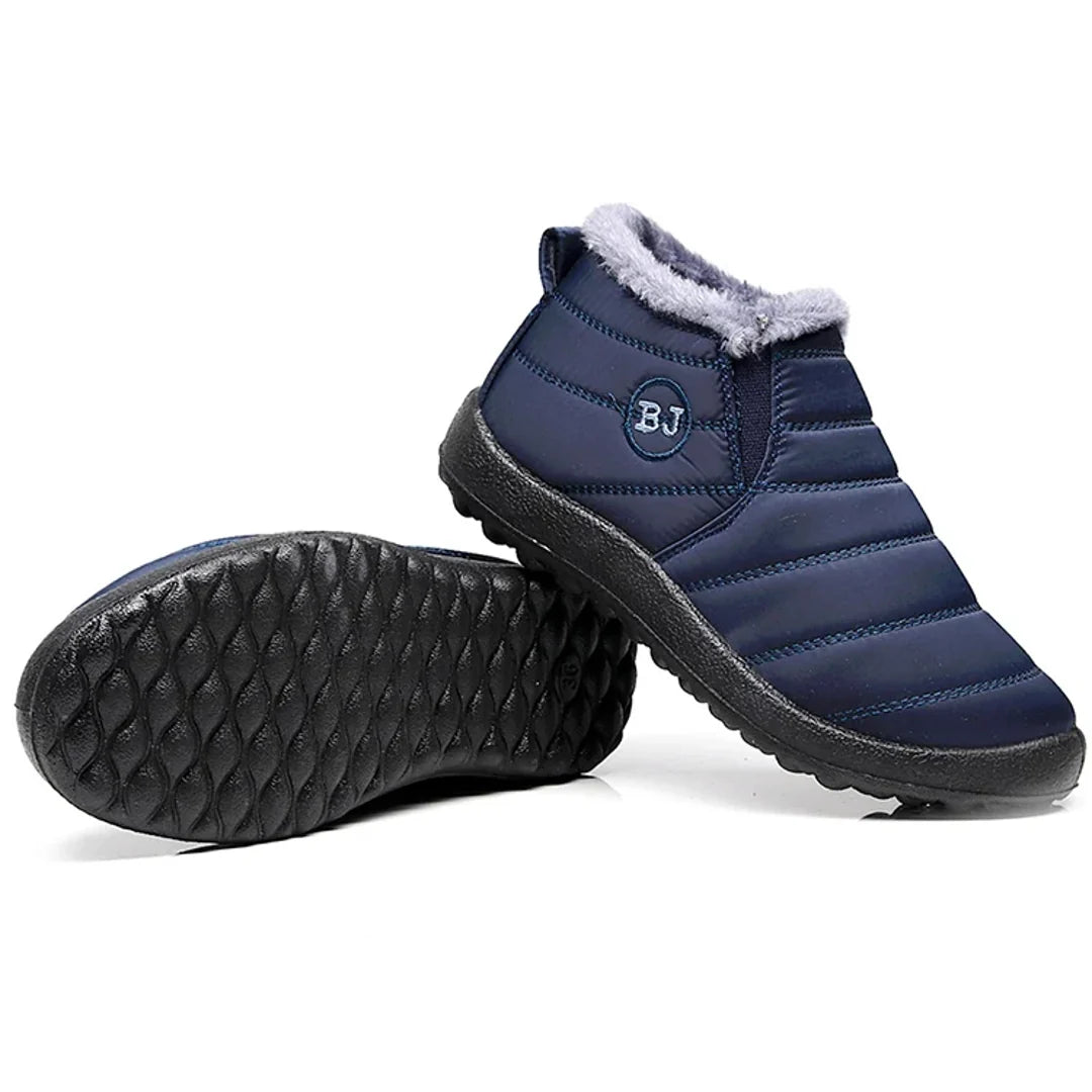 Women's navy quilted boots showing the tread sole