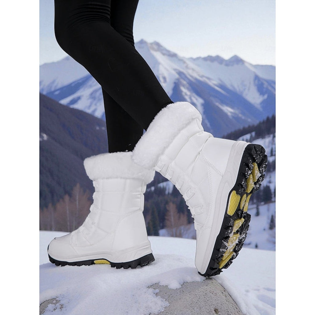 Women's white snow boot showing the tread sole