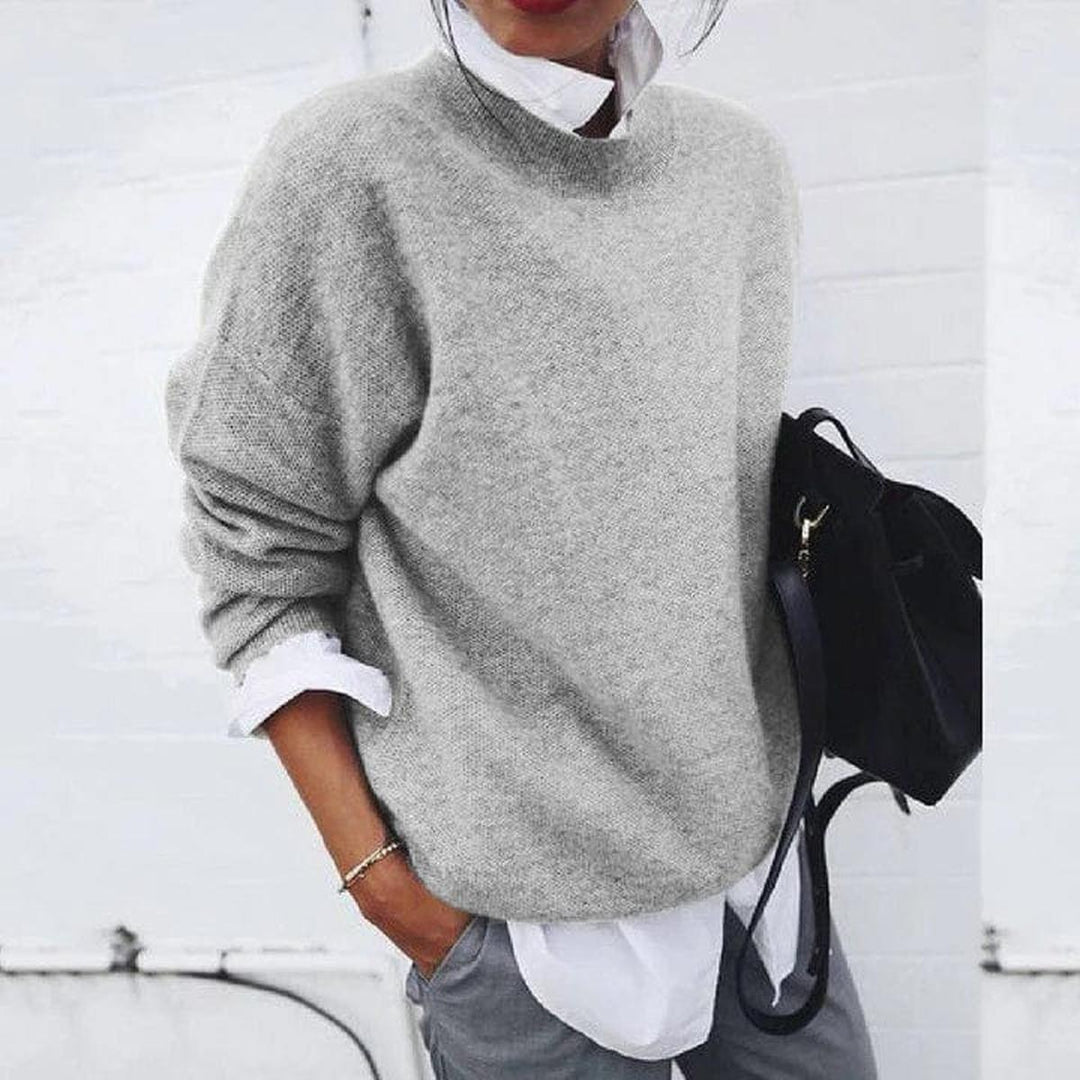 Woman wearing a grey relaxed knit sweater