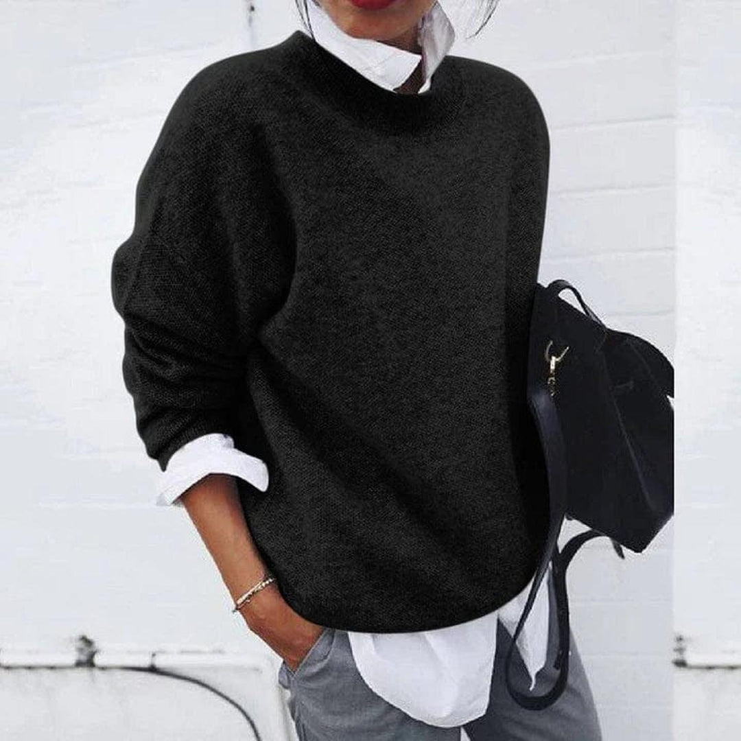 Woman wearing a black loose knit sweater