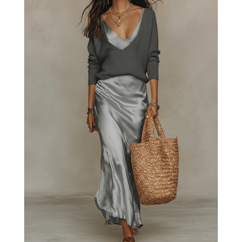 Woman wearing a grey satin dress and sweater set
