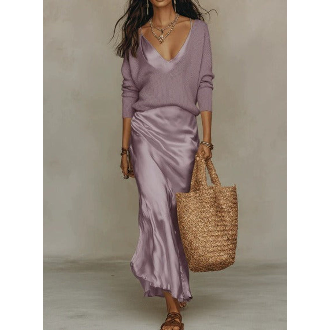Woman wearing a purple satin dress with knit sweater