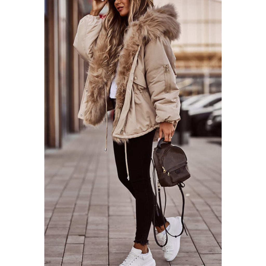 Woman wearing a beige short parka with fluffy hood trim