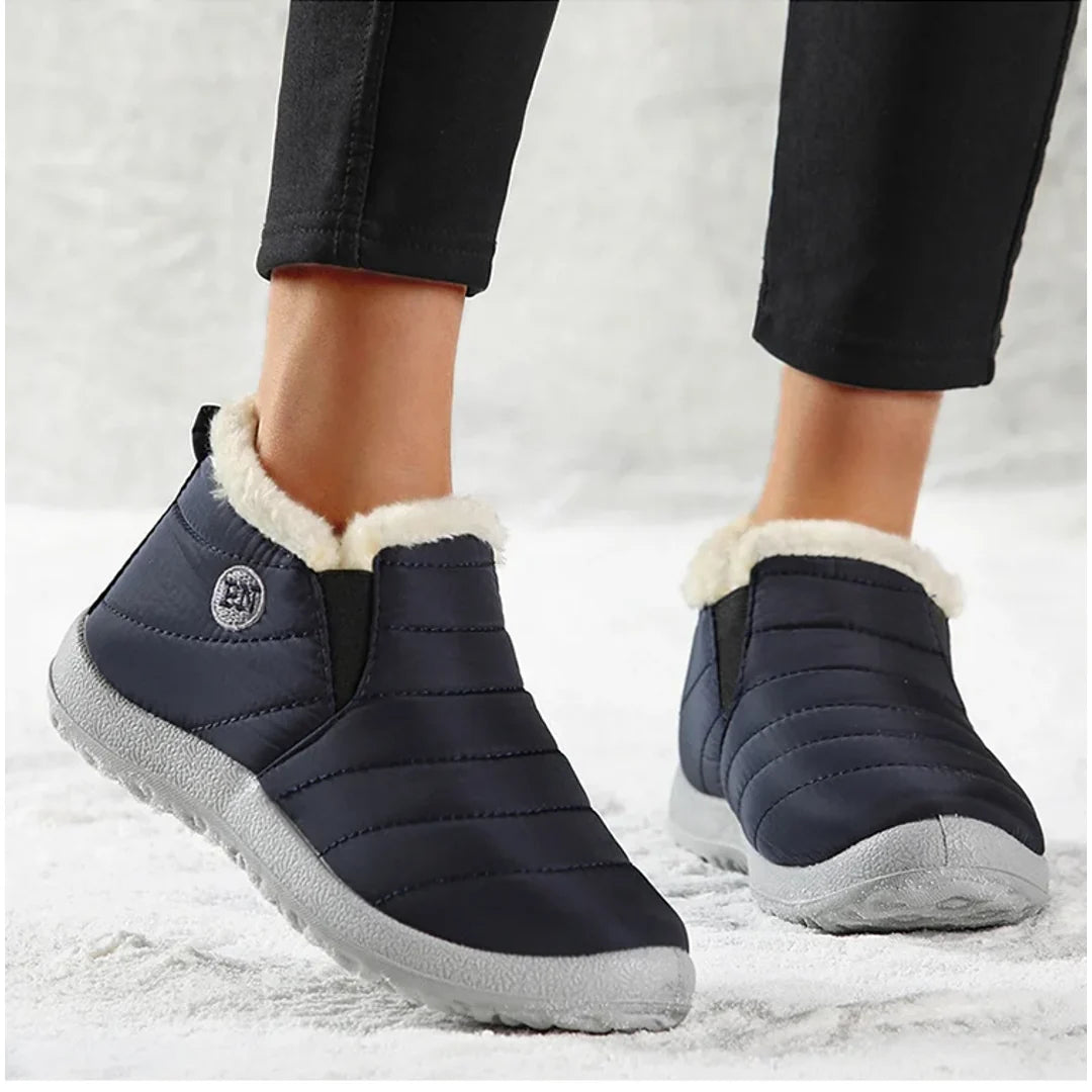 Woman wearing navy quilted ankle boots