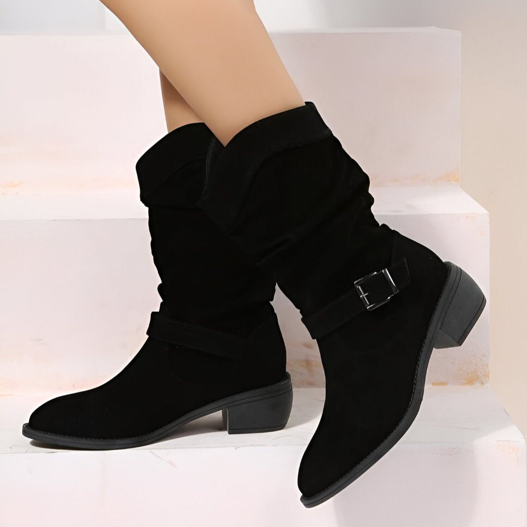 Woman wearing black slouchy mid-calf boots with buckle