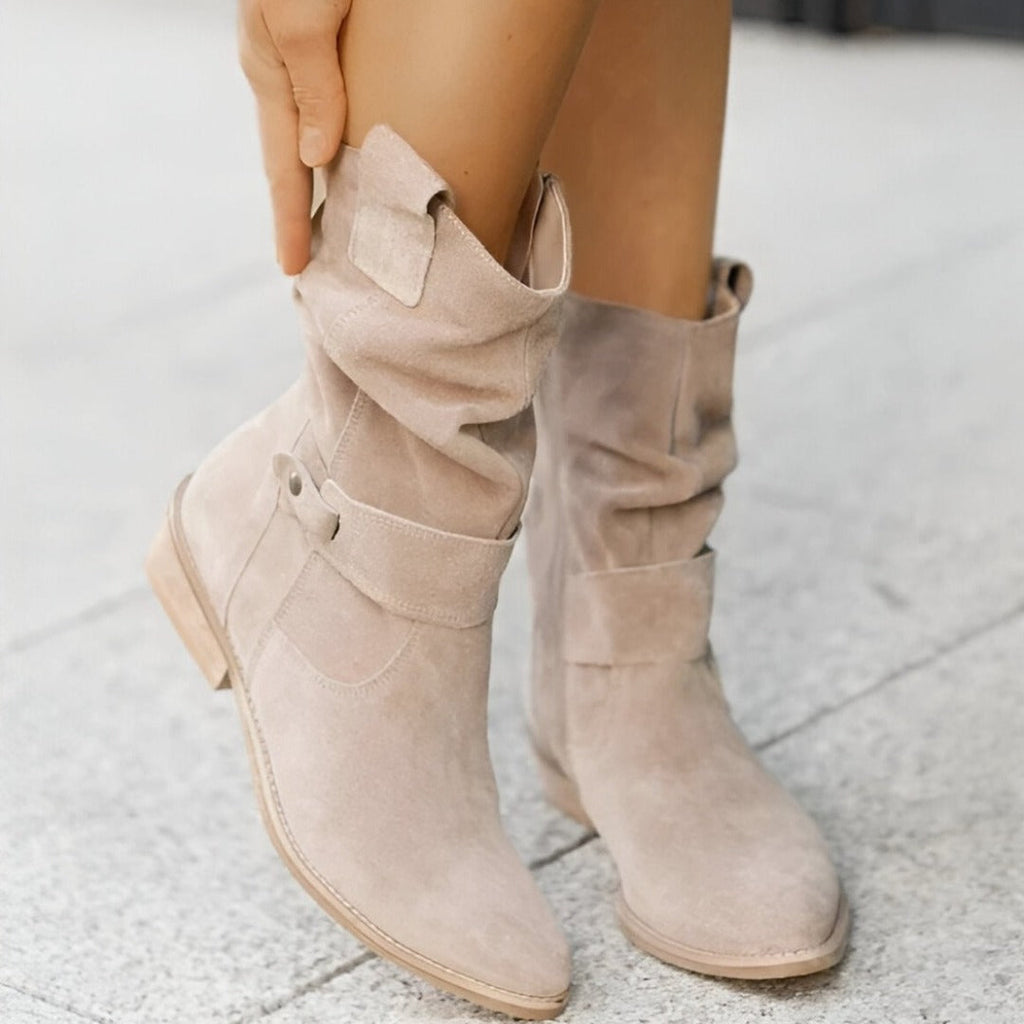 Woman wearing beige slouchy mid-calf boots