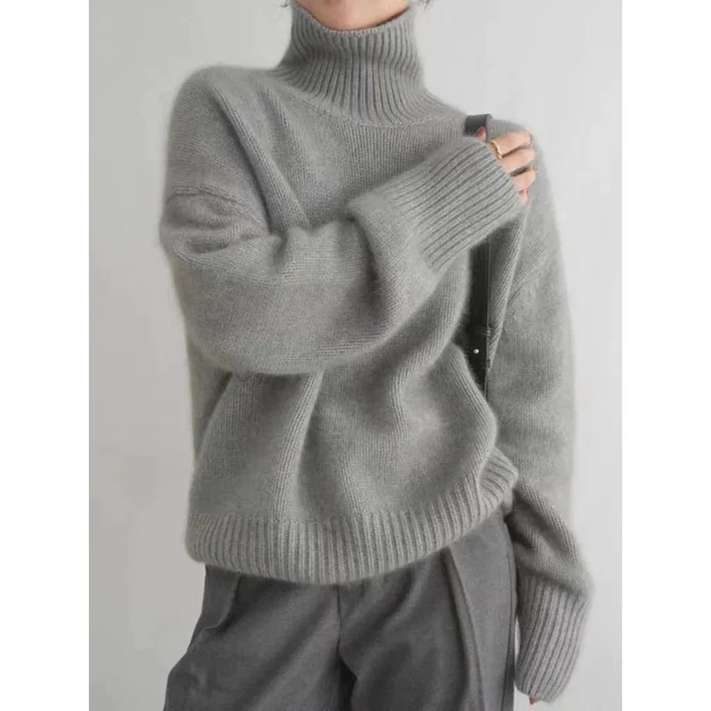 Woman wearing a grey roll neck sweater