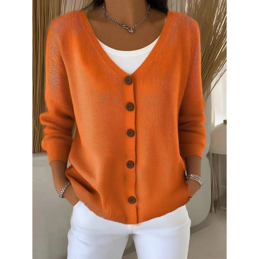 Woman wearing an orange V-neck button cardigan