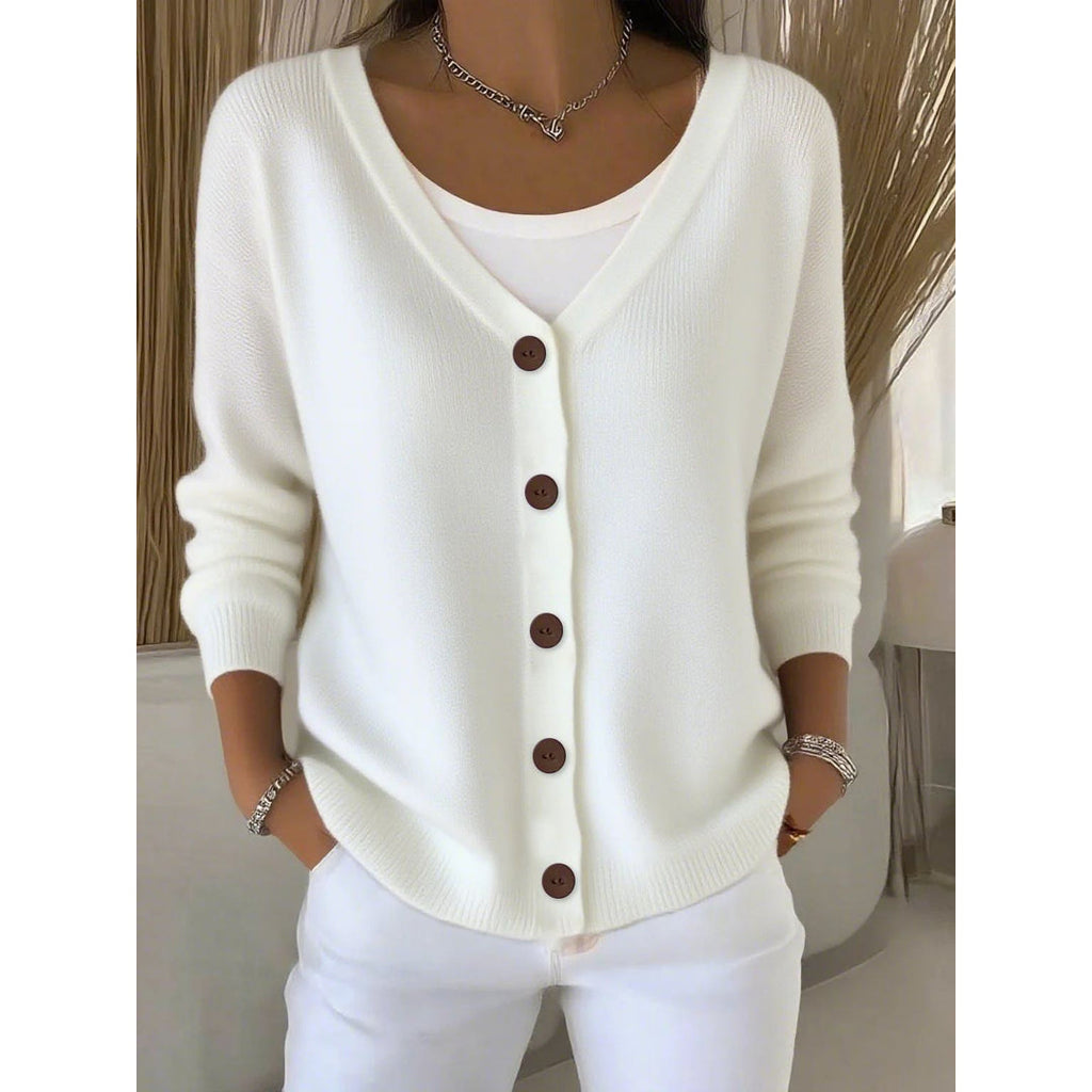 Woman wearing a white V-neck cardigan with brown buttons