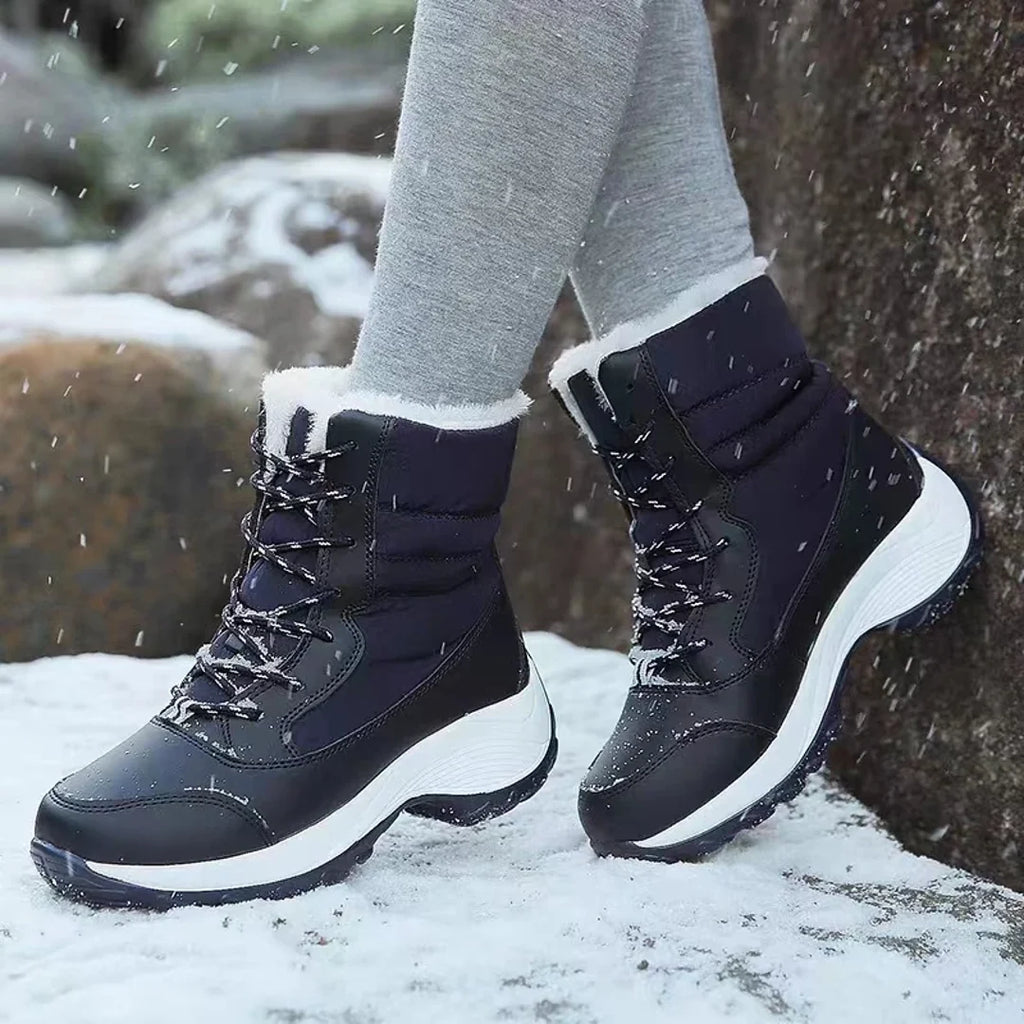 Woman wearing navy snow boots outdoors
