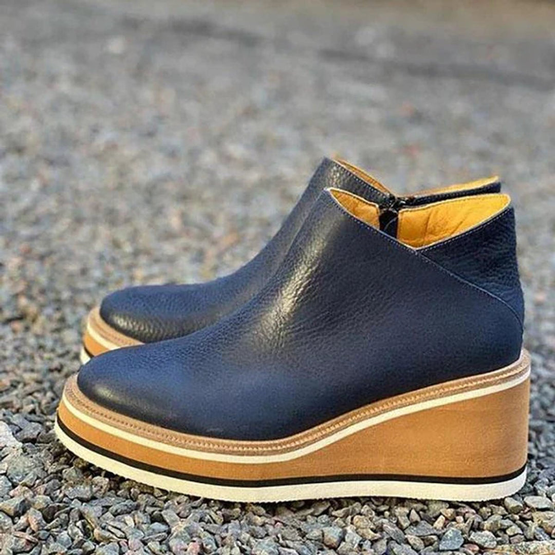Navy wedge platform ankle boots on gravel
