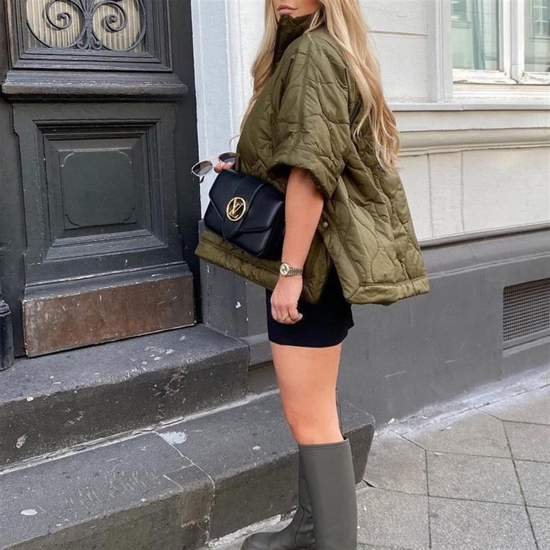 Olive green quilted cape jacket – side view with knee-high boots